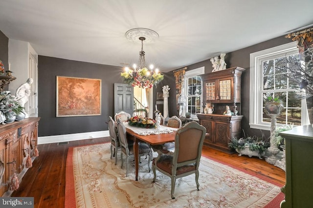 dining room featuring a notable chandelier and dark hardwood / wood-style flooring