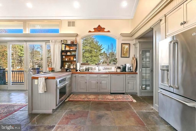 kitchen featuring wood counters, sink, a wealth of natural light, and appliances with stainless steel finishes