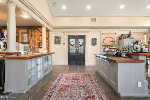 entrance foyer with french doors, sink, and ornate columns