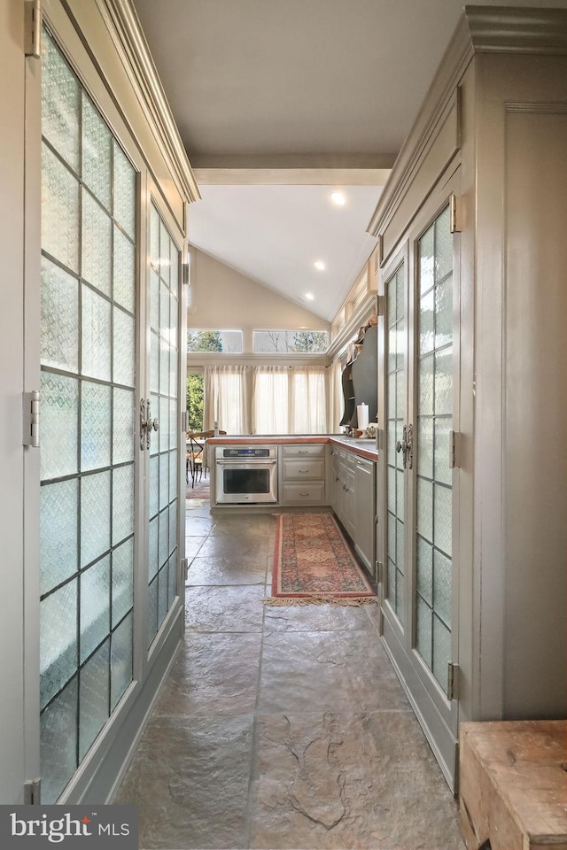 corridor with lofted ceiling and french doors