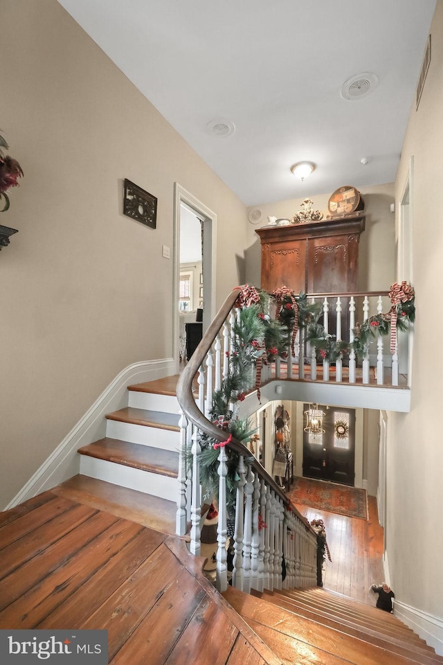 stairs with hardwood / wood-style flooring