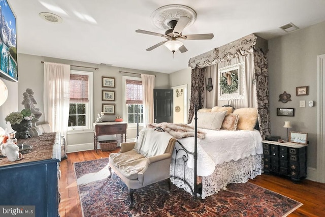 bedroom with dark hardwood / wood-style floors and ceiling fan