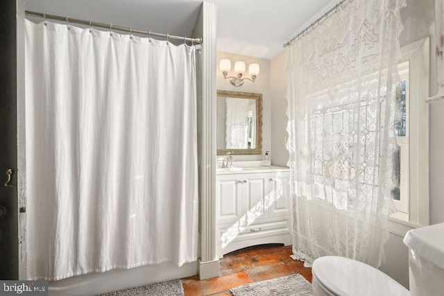 full bathroom with tile patterned flooring, vanity, shower / tub combo with curtain, and toilet