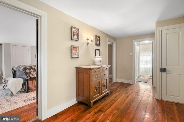 corridor featuring dark wood-type flooring