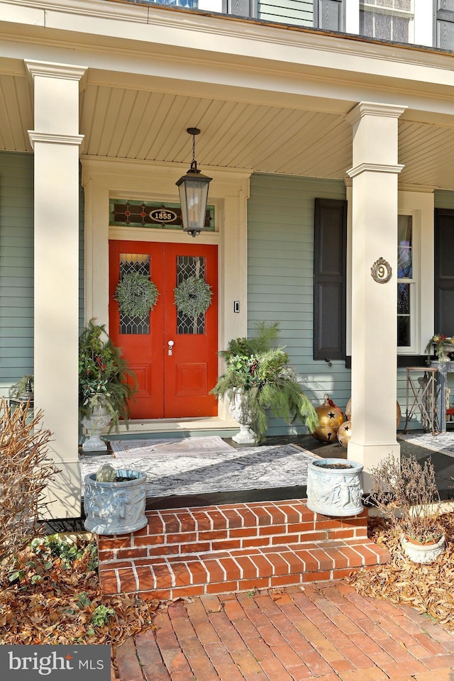 property entrance featuring french doors and covered porch