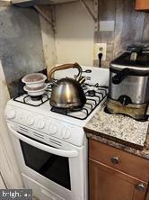 kitchen featuring white range with gas cooktop