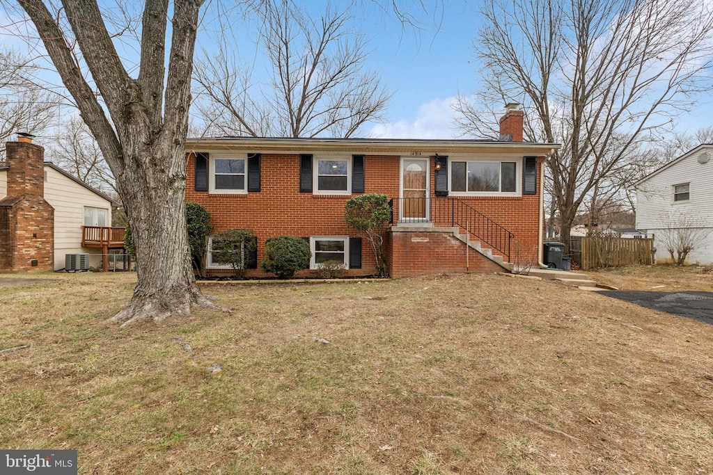 view of front of home featuring a front lawn and central air condition unit