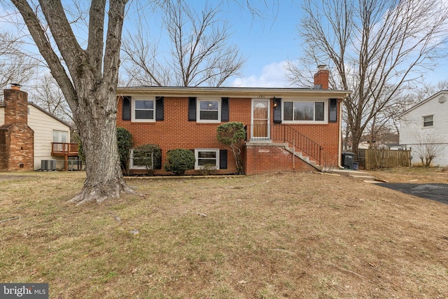 view of front of home featuring a front lawn and central air condition unit