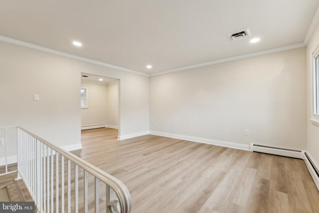 empty room with a baseboard heating unit, crown molding, and light wood-type flooring