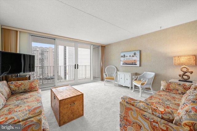 carpeted living room with a wall of windows and a textured ceiling