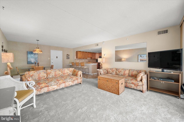 carpeted living room with a textured ceiling