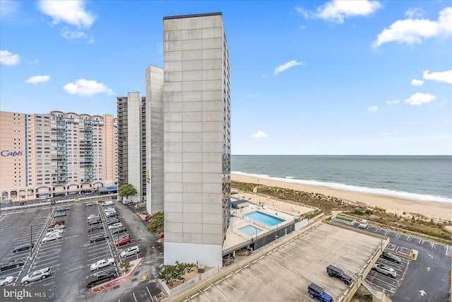 exterior space with a water view and a view of the beach