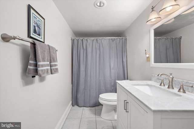 bathroom featuring tile patterned flooring, vanity, and toilet