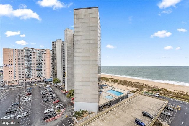 exterior space featuring a beach view and a water view