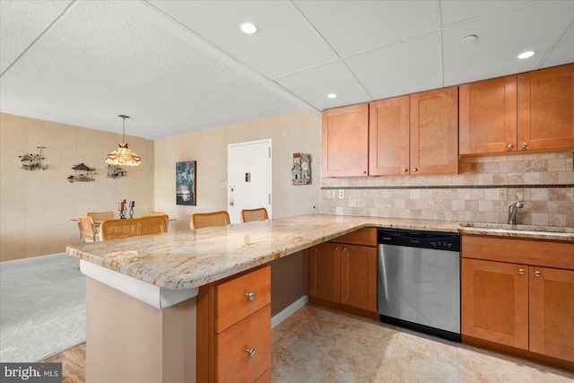 kitchen featuring sink, a breakfast bar area, stainless steel dishwasher, and kitchen peninsula