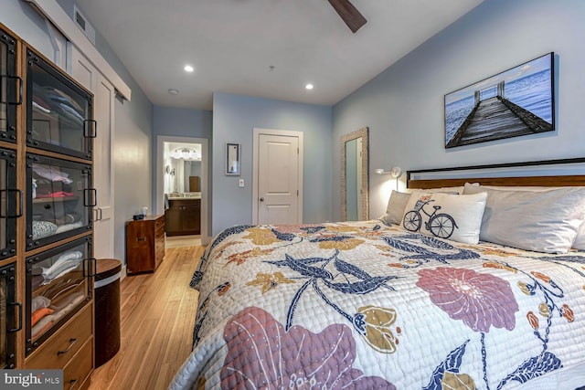 bedroom with ceiling fan, connected bathroom, and light wood-type flooring