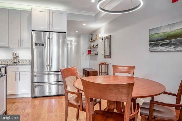 dining space with light wood-type flooring