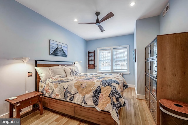 bedroom with ceiling fan and light hardwood / wood-style flooring