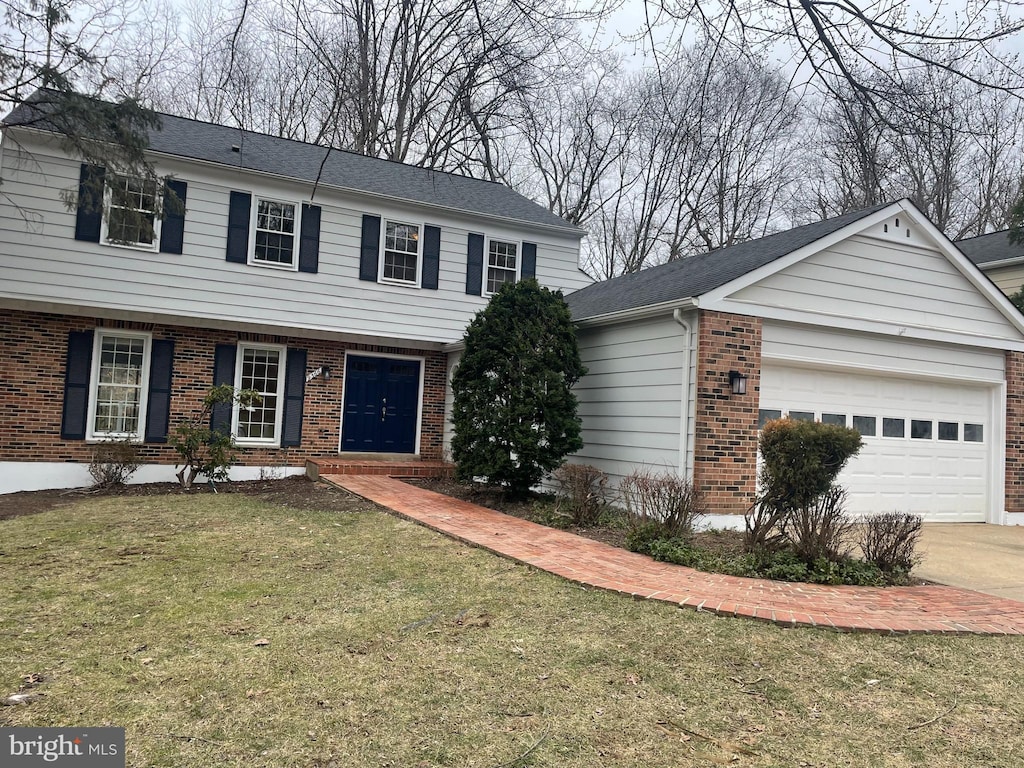 view of front of property with a garage and a front lawn