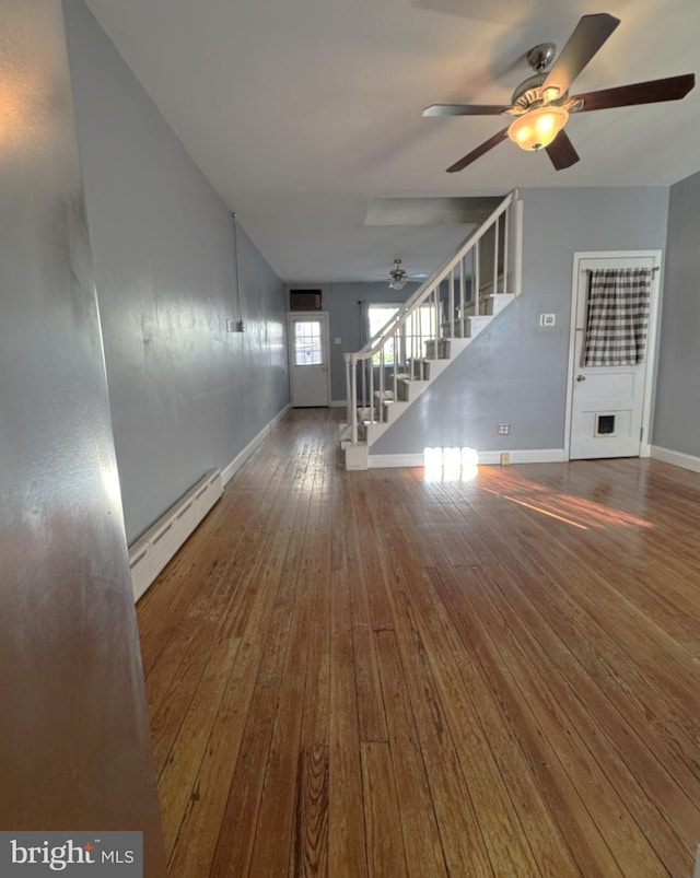 interior space with ceiling fan, a baseboard radiator, and dark hardwood / wood-style flooring