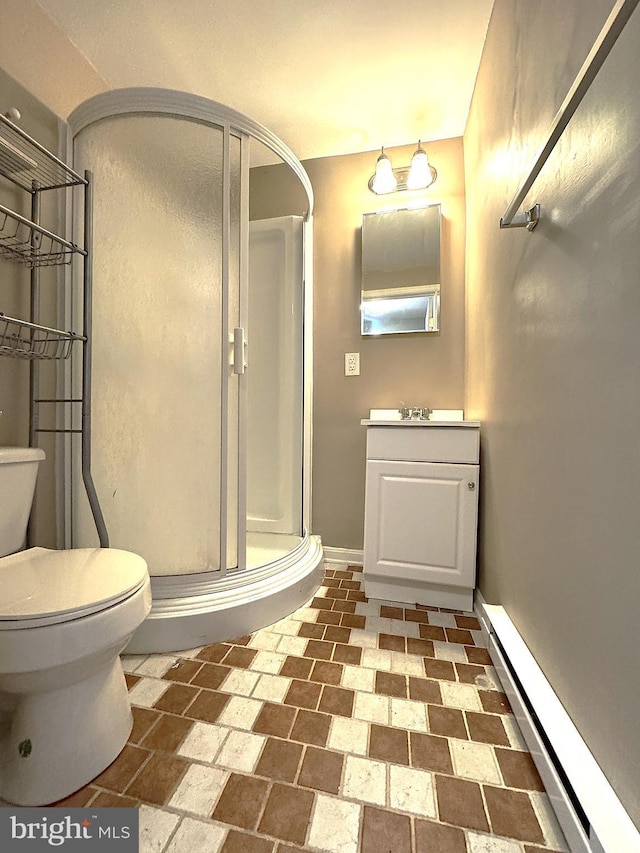 bathroom featuring baseboard heating, vanity, toilet, and a shower with shower door