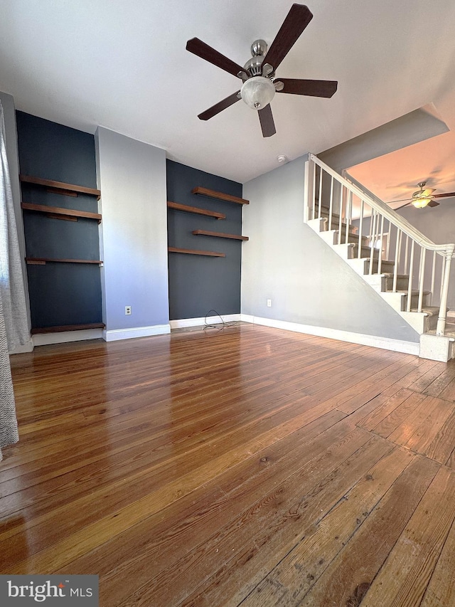 unfurnished living room featuring hardwood / wood-style flooring and ceiling fan