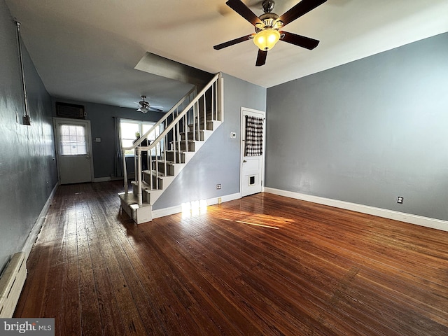 unfurnished living room with ceiling fan, hardwood / wood-style floors, and a baseboard heating unit