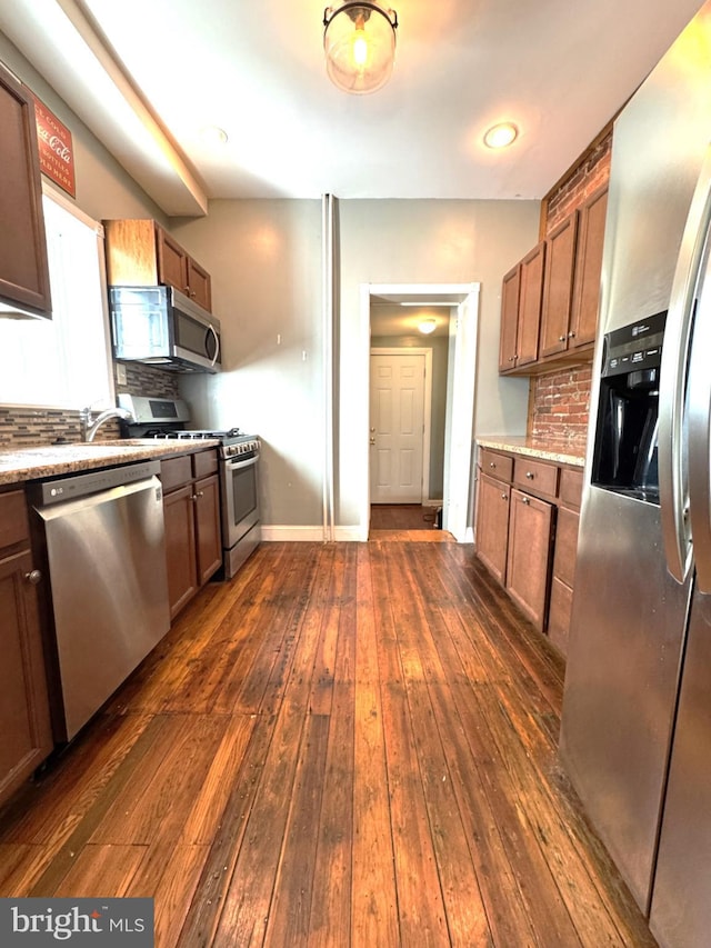 kitchen with stainless steel appliances and dark hardwood / wood-style flooring