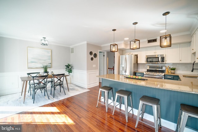 kitchen featuring visible vents, light stone counters, decorative backsplash, white cabinets, and stainless steel appliances