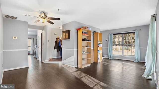 interior space featuring ceiling fan and dark wood-type flooring