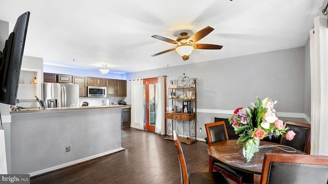 dining room with ceiling fan and dark wood-type flooring