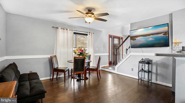 dining space with ceiling fan and dark hardwood / wood-style flooring