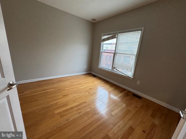 spare room with light hardwood / wood-style flooring