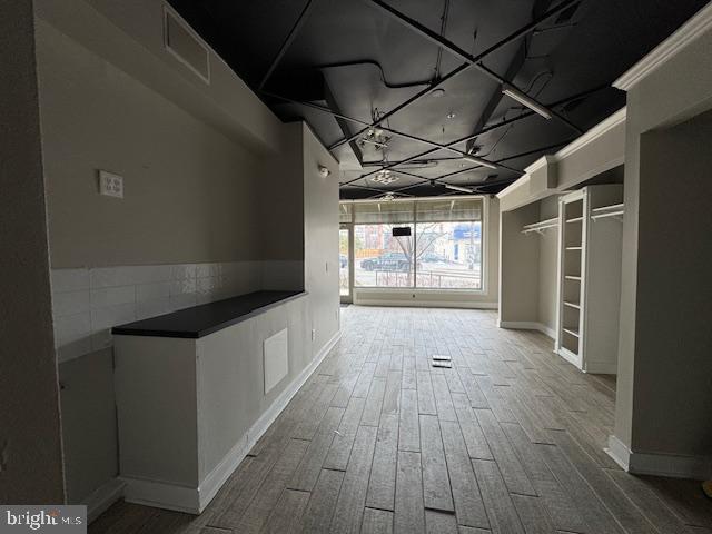 corridor featuring hardwood / wood-style floors