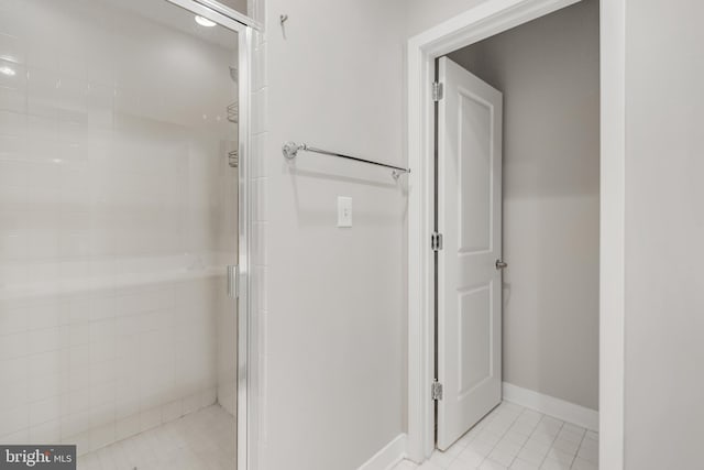 bathroom featuring a shower with door and tile patterned floors