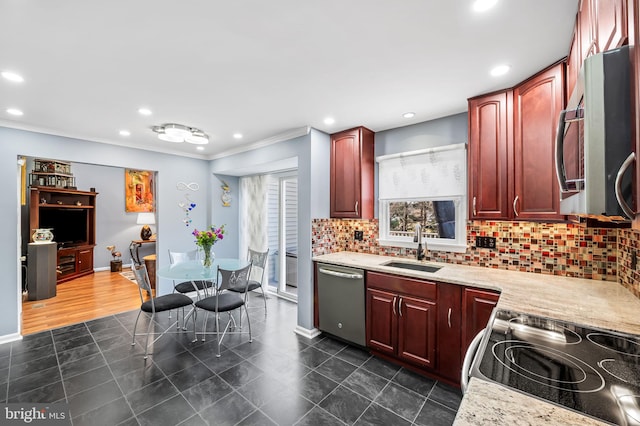 kitchen with tasteful backsplash, sink, light stone counters, stainless steel appliances, and crown molding