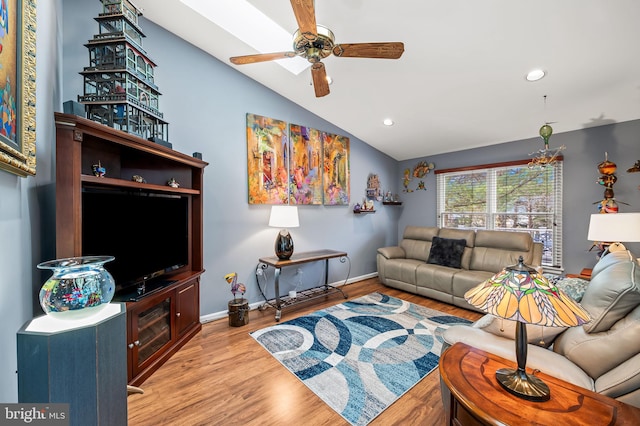 living room with lofted ceiling, ceiling fan, and light hardwood / wood-style flooring