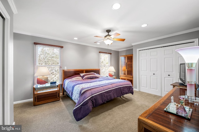 carpeted bedroom featuring crown molding, ceiling fan, and a closet