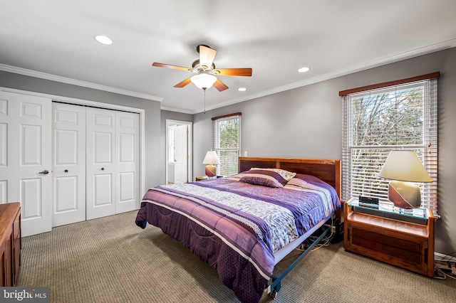 bedroom with carpet floors, ornamental molding, a closet, and ceiling fan