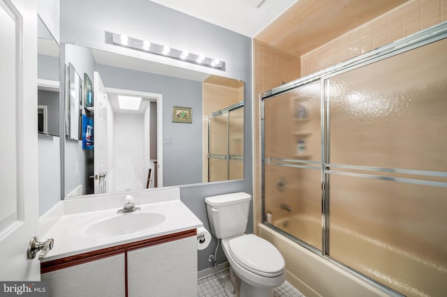 full bathroom with vanity, combined bath / shower with glass door, tile patterned floors, and toilet