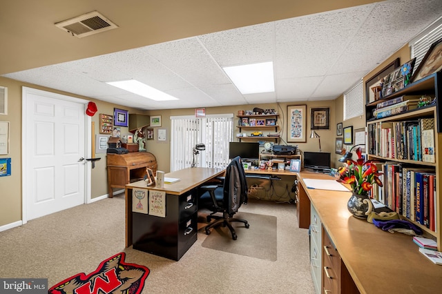 home office featuring a drop ceiling and light colored carpet