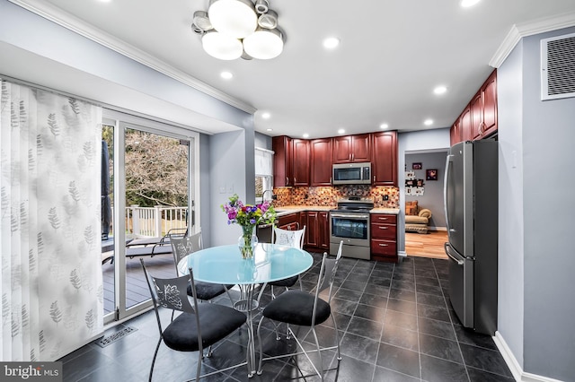 kitchen featuring tasteful backsplash, crown molding, appliances with stainless steel finishes, and dark tile patterned flooring