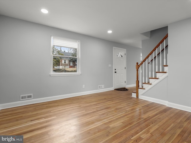 entrance foyer with visible vents, baseboards, light wood-style flooring, stairway, and recessed lighting