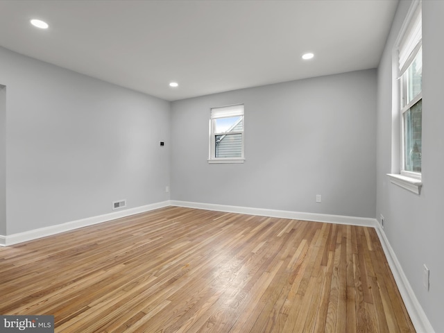 spare room with light wood-style flooring, visible vents, baseboards, and recessed lighting