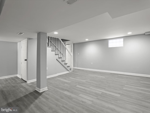 basement featuring stairs, recessed lighting, wood finished floors, and baseboards