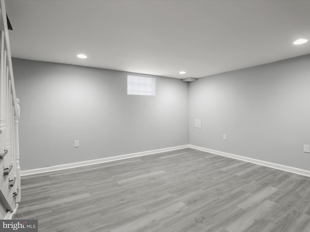 below grade area featuring light wood-type flooring, baseboards, and recessed lighting