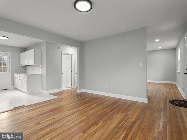 unfurnished living room featuring baseboards, recessed lighting, visible vents, and light wood-style floors