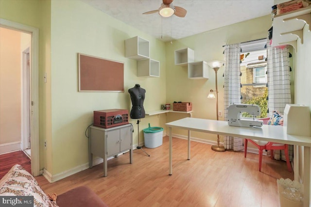 home office with ceiling fan and light wood-type flooring