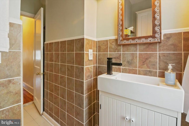 bathroom with tile walls, vanity, and tile patterned floors