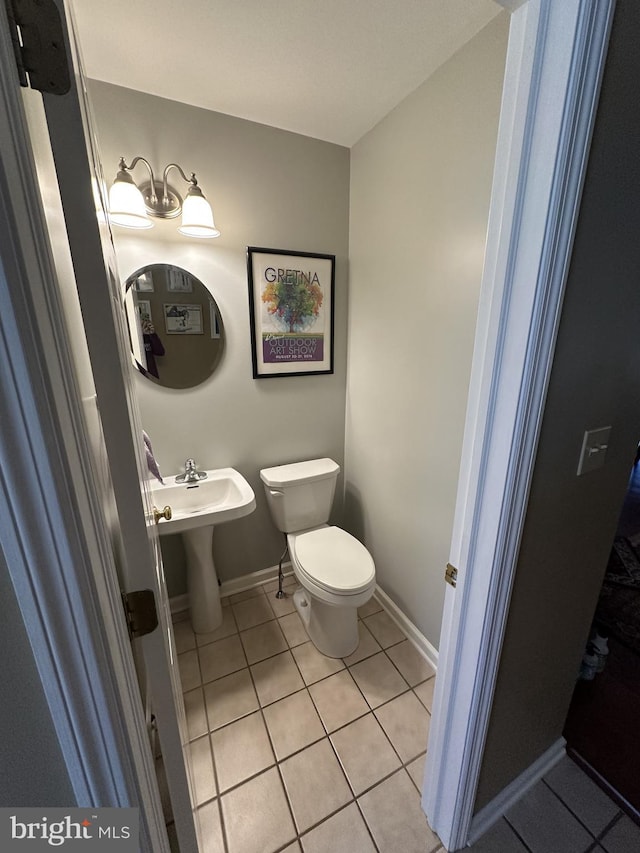 bathroom with tile patterned floors and toilet